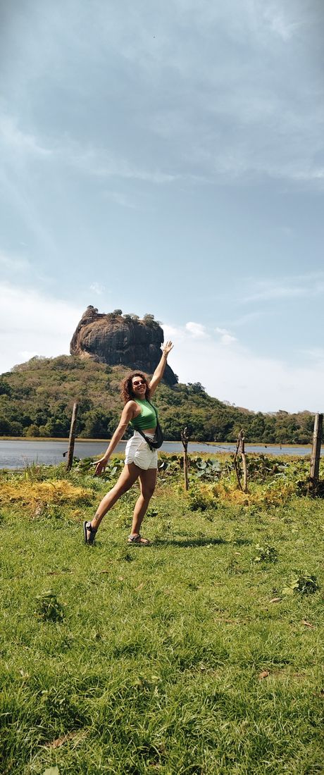 Arms up in front of the Sigiriya rock fortress, Sri Lanka