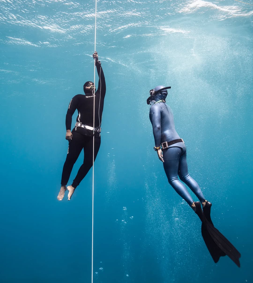 Two freedivers training on the line